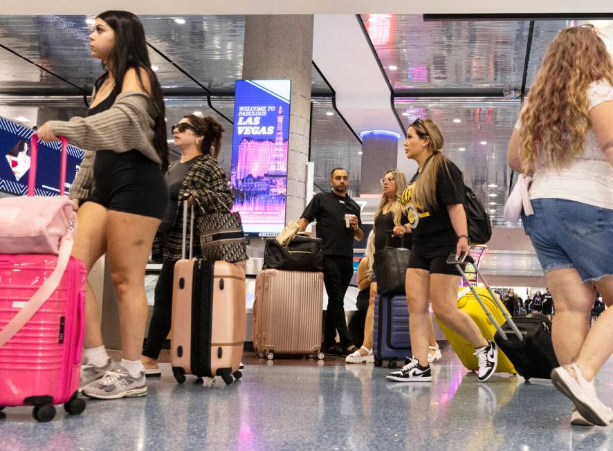 Arriving passengers head to baggage claim area at Terminal 1 of Harry Reid International Airpor ...