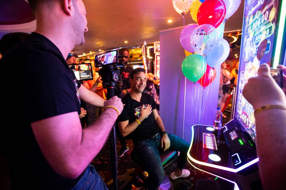 YouTuber Brian Christopher, left, livestreams as his husband, Marco, plays on the new slot mach ...