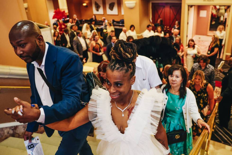 Couples walk up the stairs into the Octavius Ballroom to renew their vows during a ceremony wit ...