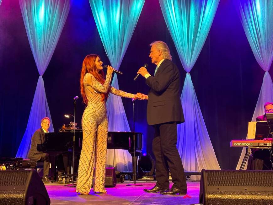 Anne Martinez and Bill Medley perform during a wedding vow-renewal ceremony for nearly 300 coup ...