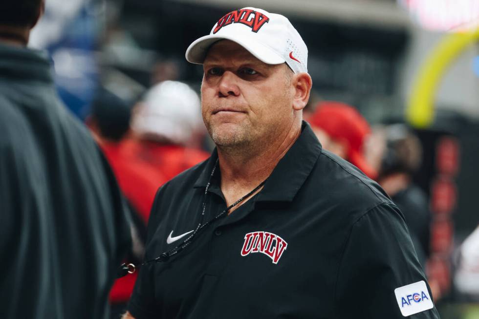 UNLV head football coach Barry Odom walks off the field with his team to get ready for their se ...