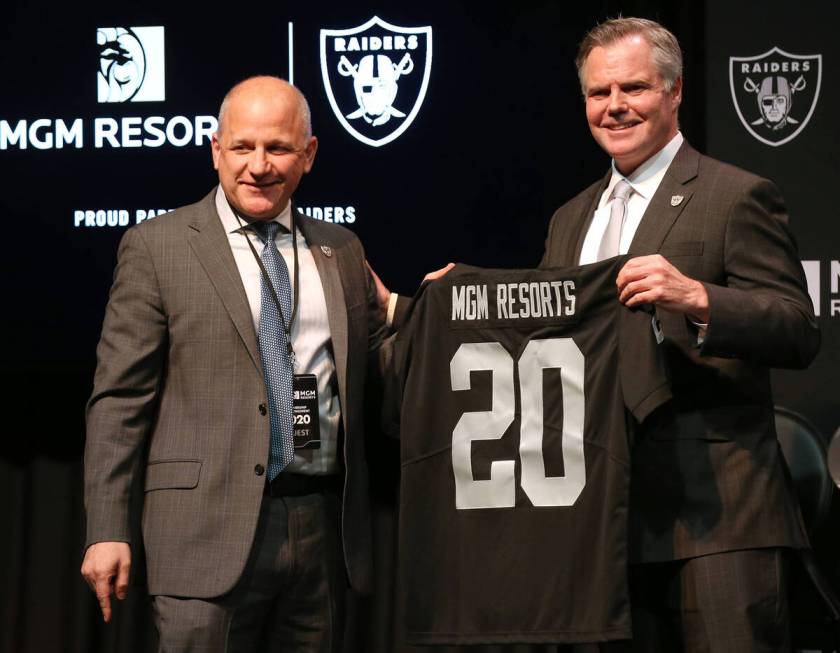 FILE - Raiders president Marc Badain, left, and Jim Murren, MGM Resorts CEO and chairman, annou ...