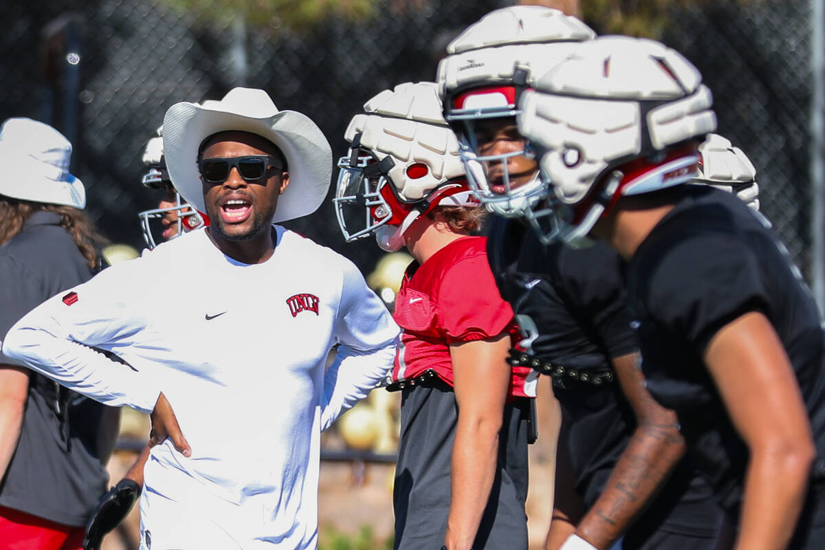 UNLV football offensive coordinator Brennan Marion coaches his players at a UNLV football pract ...