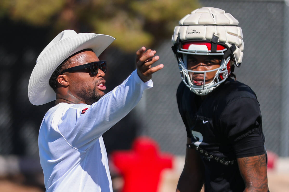 UNLV football offensive coordinator Brennan Marion talks to his players at a UNLV football prac ...