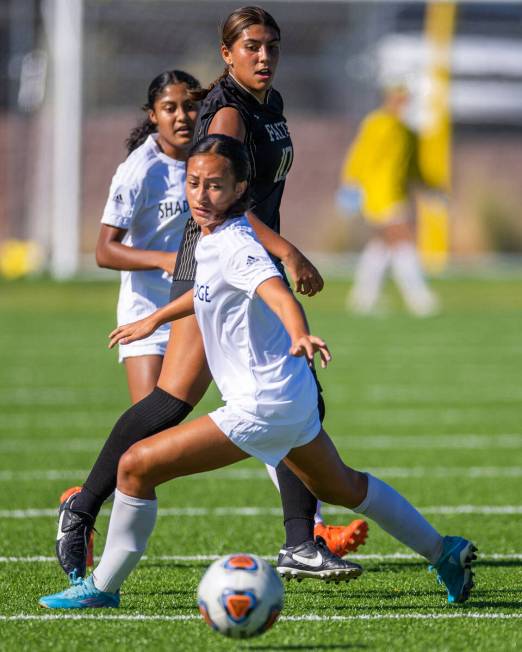 Shadow Ridge midfielder Carmen Loo (7) looks to a pass as Faith Lutheran midfielder Andrea Lev ...