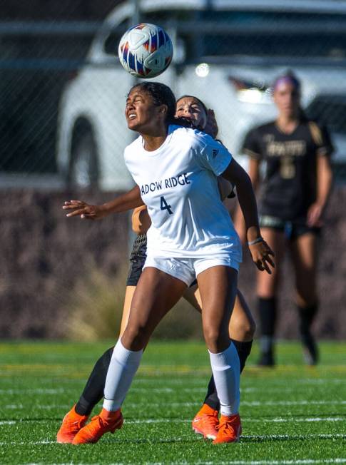 Shadow Ridge midfielder Natalia Nuno (4) heads the ball over a Faith Lutheran player during the ...