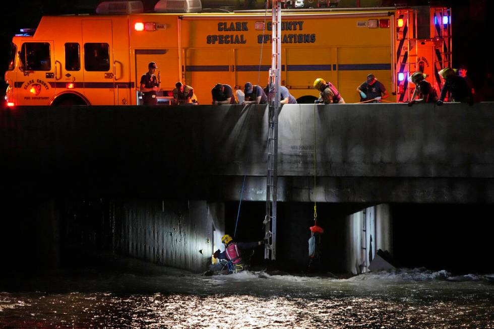 Clark County Fire Department officials search for a man who was trapped in floodwaters in a flo ...
