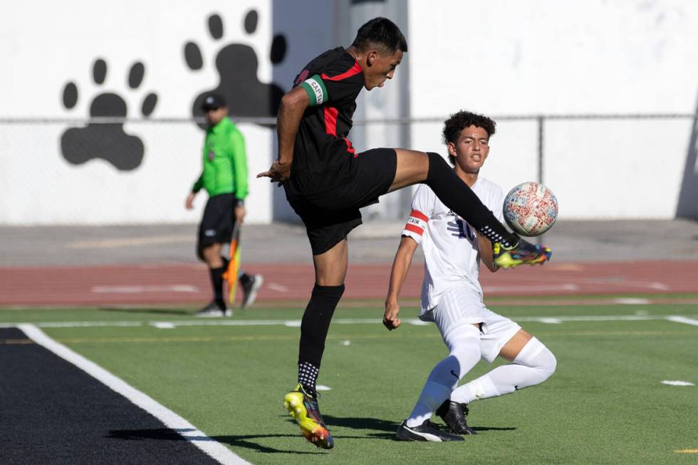 Las Vegas' Ariel Lopez Trujillo (3) blocks an attempted goal while Sunrise Mountain's Michael U ...