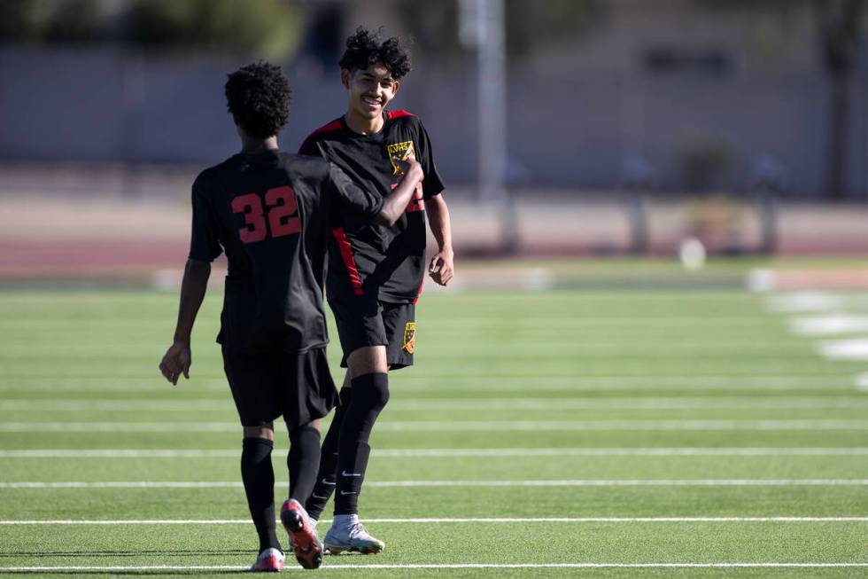 Las Vegas' Jordan Brown (32) celebrates his goal with teammate Lex Madrigal (42) during a boys ...