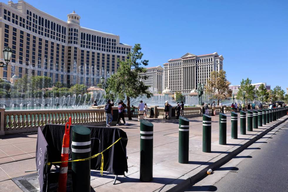 Barricades block off stumps from trees cut down in front of the Bellagio on the Strip in Las Ve ...