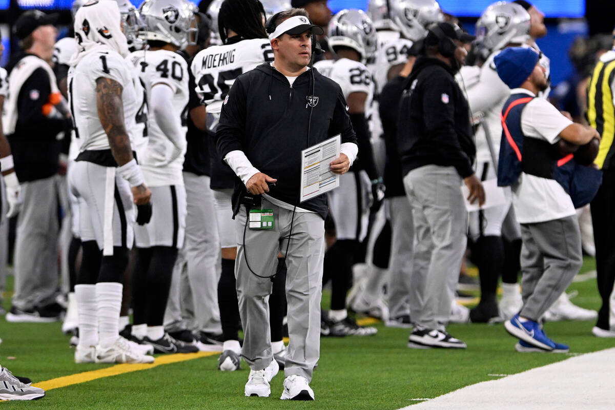 Las Vegas Raiders head coach Josh McDaniels walks the sidelines during the first half of a pres ...