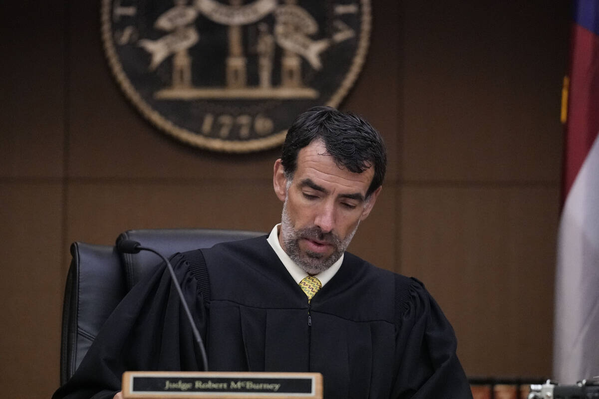 FILE - Fulton County Superior Court Judge Robert McBurney looks through paperwork, Monday, Aug. ...