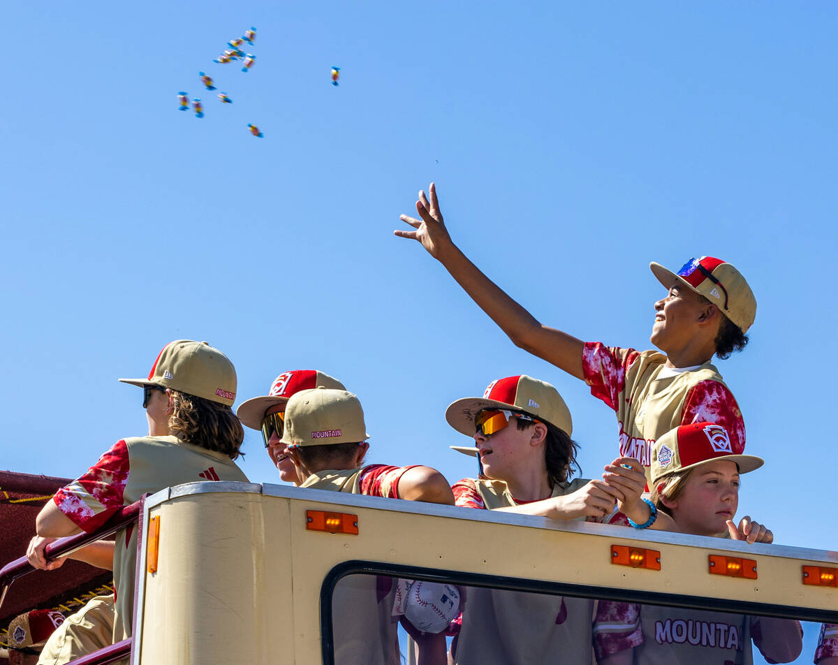 Henderson Little League team player JoJo Dixon (14) tosses bubblegum to fans as the team and co ...