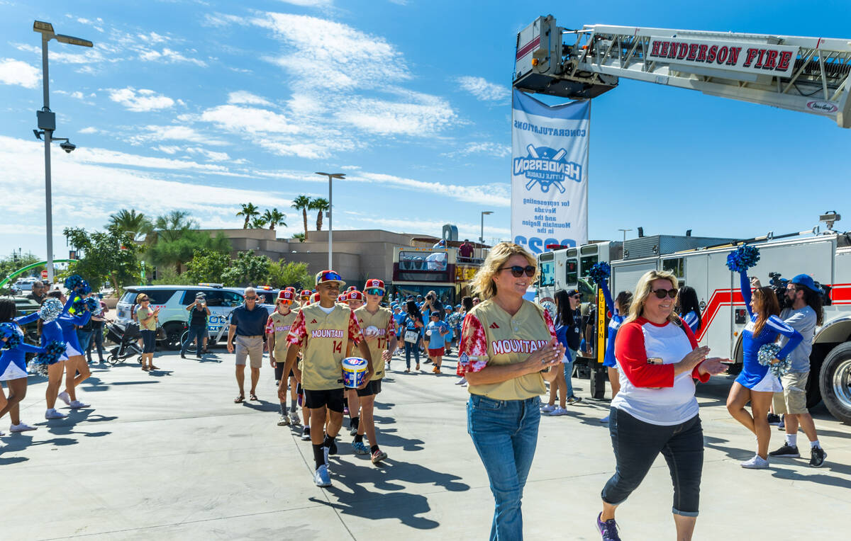 Mayor Michelle Romero, center, and Councilwoman Carrie Cox lead in the Henderson Little League ...