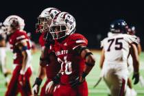 Liberty defensive back Maximus Paogofie walks off the field during a turnover at an Island Clas ...