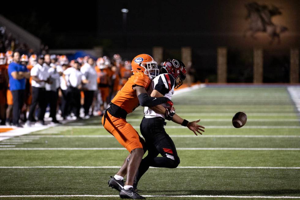 Bishop Gorman's Jett Washington (5) stops Centennial quarterback Husan Longstreet (4) from catc ...