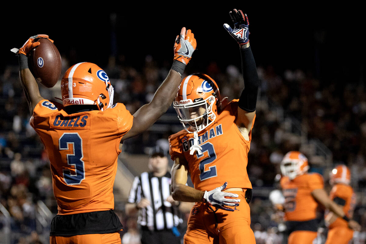 Bishop Gorman’s Devon Rice (3) and Audric Harris (2) celebrate Rice’s touchdown d ...