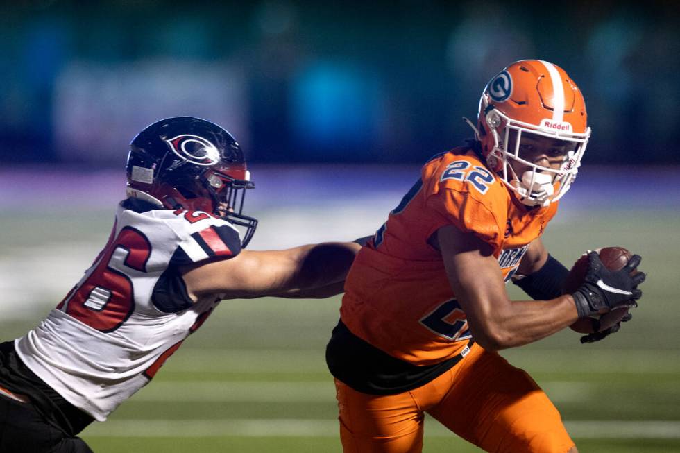 Bishop Gorman running back Micah Kaapana (22) runs the ball against Centennial outside lineback ...