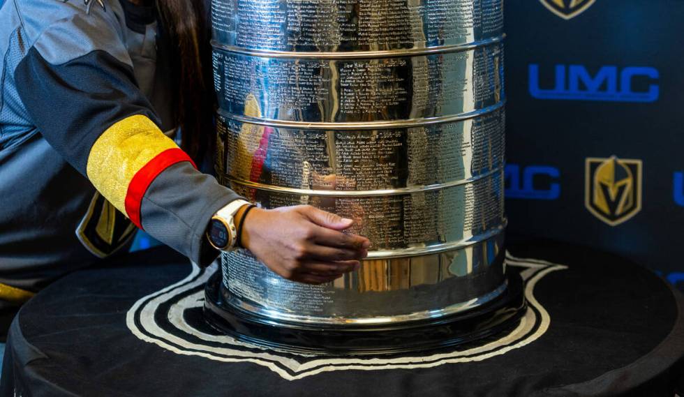 A UMC Hospital worker poses with the Stanley Cup during a visit for employees presented by the ...