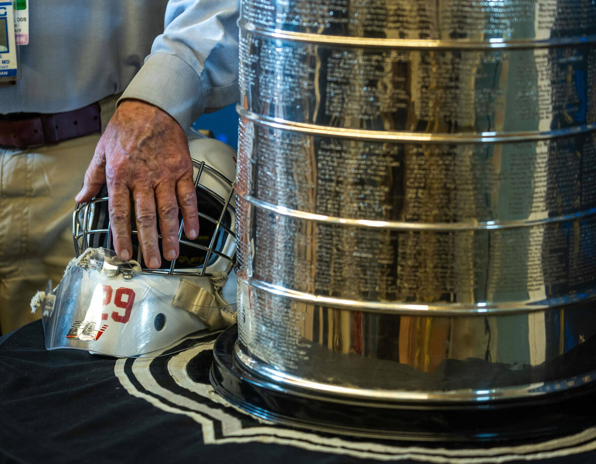 A UMC Hospital worker poses with the Stanley Cup and old hockey mask during a visit for employe ...