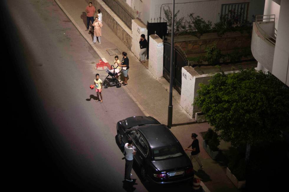 People take shelter outside their homes after an earthquake in Rabat, Morocco, Friday, Sept. 8, ...