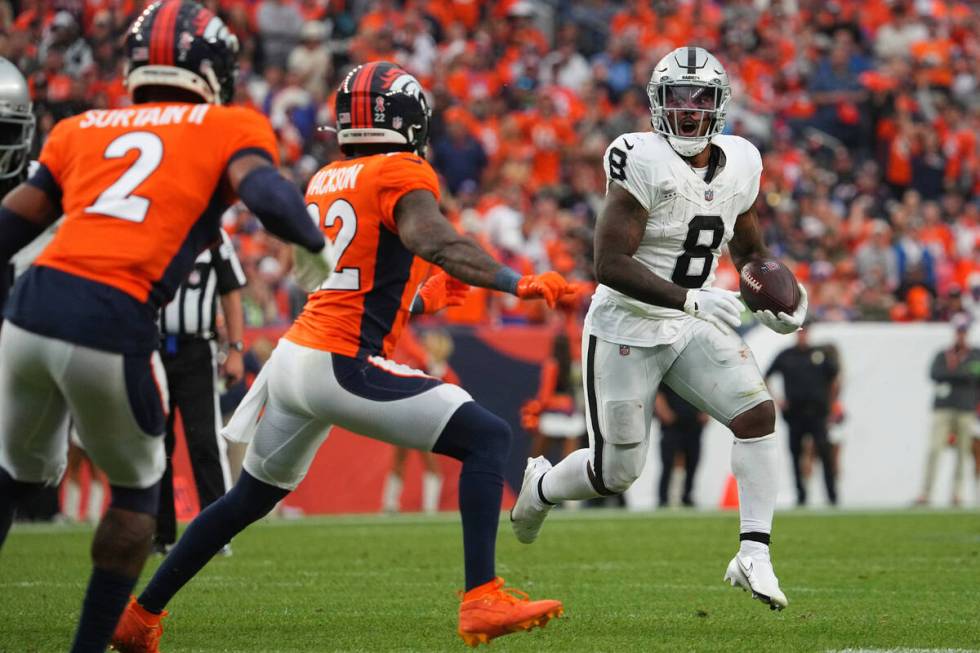 Las Vegas Raiders running back Josh Jacobs (8) runs the ball against the Denver Broncos of an N ...