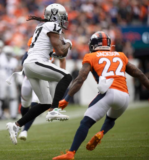 Raiders wide receiver Davante Adams (17) makes a catch for a fourth down conversion during the ...