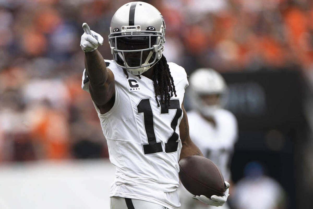 Raiders wide receiver Davante Adams (17) points to signal for a first down during the first hal ...