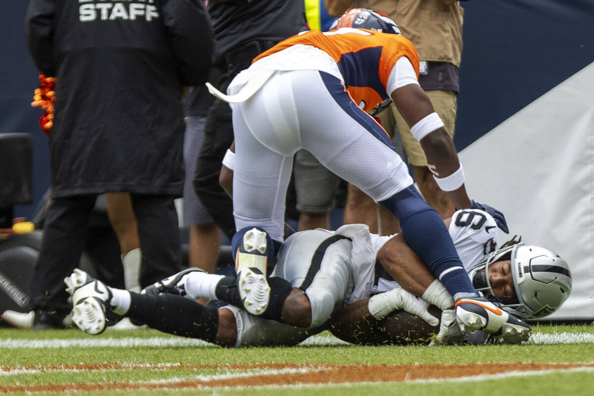 Raiders wide receiver Jakobi Meyers (16) scores a touchdown with Denver Broncos cornerback Dama ...