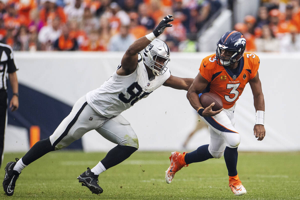 Raiders defensive tackle Jerry Tillery (90) pursues Denver Broncos quarterback Russell Wilson ( ...