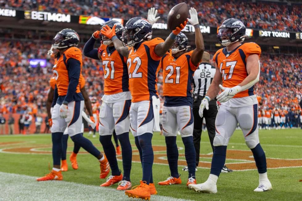 The Denver Broncos celebrate safety Kareem Jackson’s (22) interception during the second ...