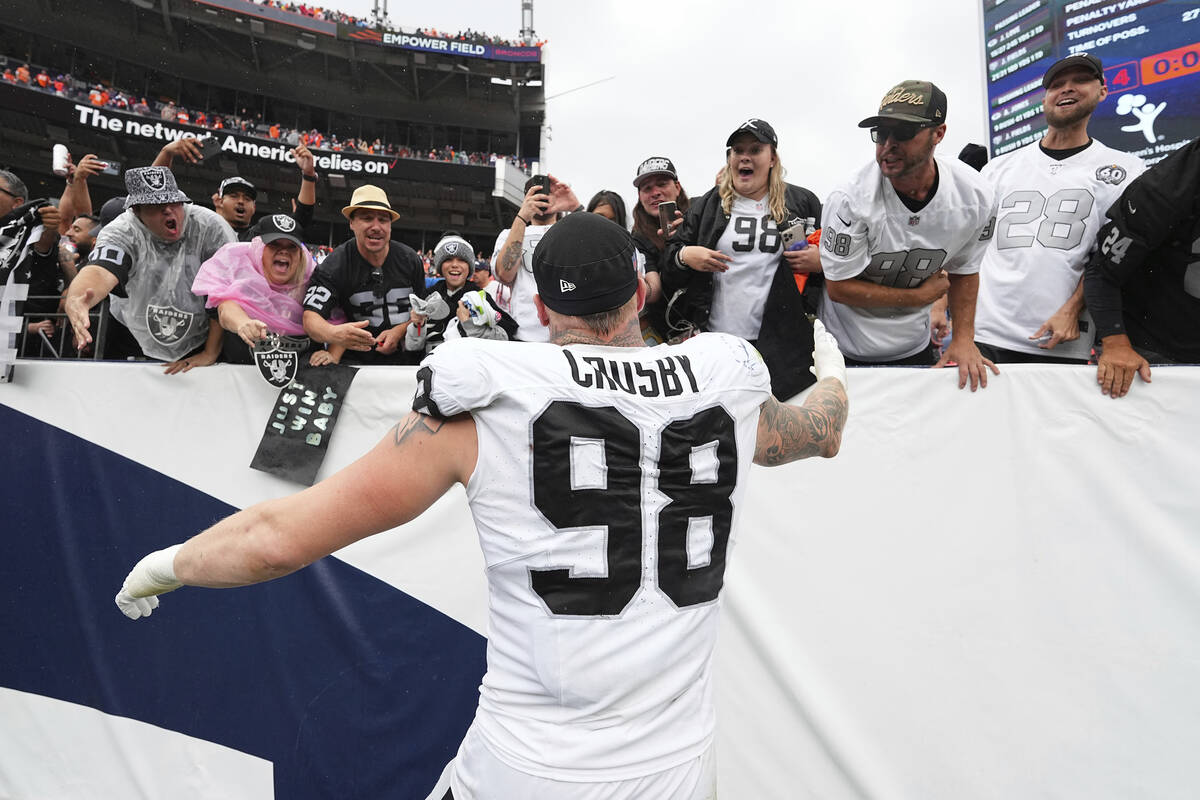 Las Vegas Raiders defensive end Maxx Crosby (98) celebrates with fans against the Denver Bronco ...