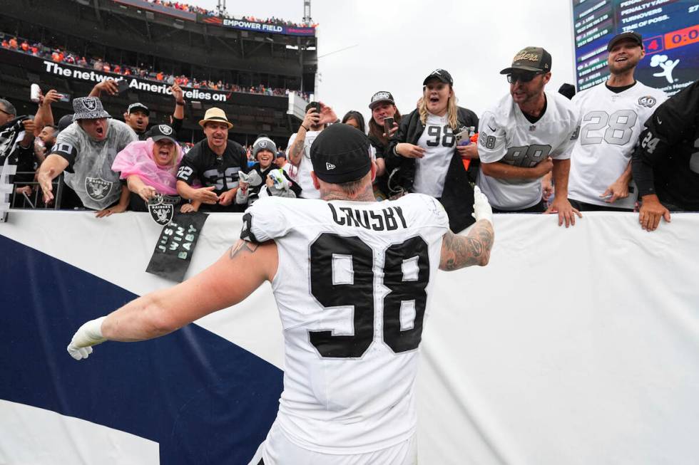 Las Vegas Raiders defensive end Maxx Crosby (98) celebrates with fans against the Denver Bronco ...