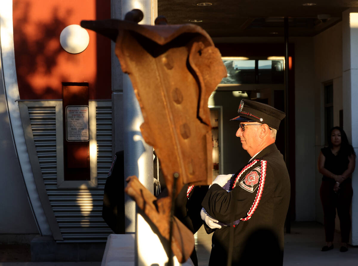 Las Vegas Firefighters Local 1285 Honor Guard member Ron Kline prepares to raise an American fl ...