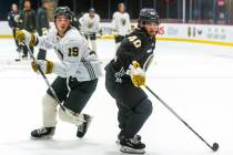 Golden Knights rookie forward Brendan Brisson (19) and defenseman Lukas Cormier (40) look to lo ...