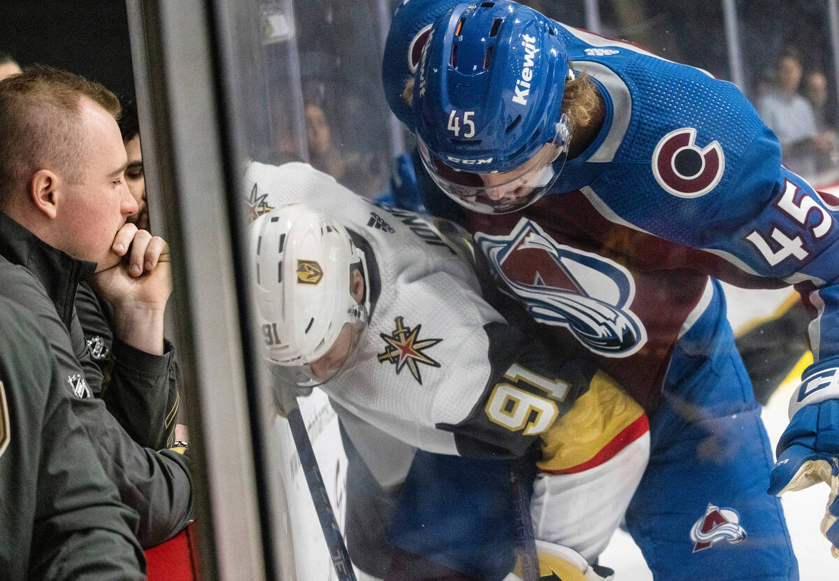 Golden Knights prospect forward Jett Jones (91) pined against the board by Colorado Avalanche M ...