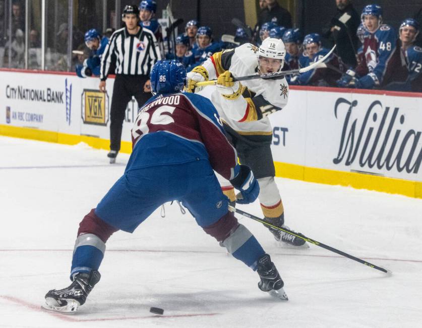 Golden Knights prospect forward Jakub Brabenec (12) hits the puck between Colorado Avalanche Mi ...