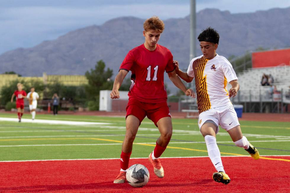 Arbor View's Aren Khanjian (11) dribbles against Eldorado's Henyor Archila, right, during a boy ...