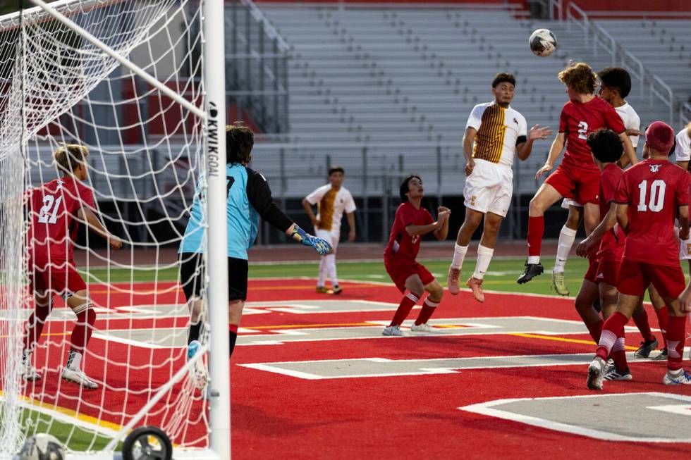 Eldorado midfielder Ángel Reveles (22) goes up for a header Arbor View's Adam Lahav (2) be ...