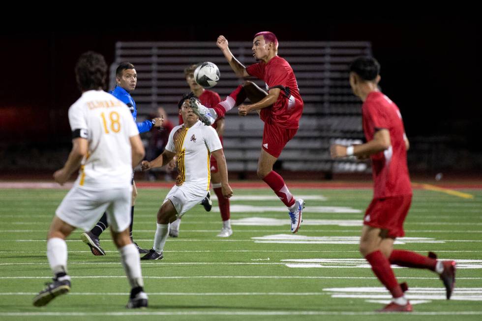 Arbor View's Oziel Gomez (10) jumps to kick while Eldorado midfielder Rogelio Berto, back cente ...