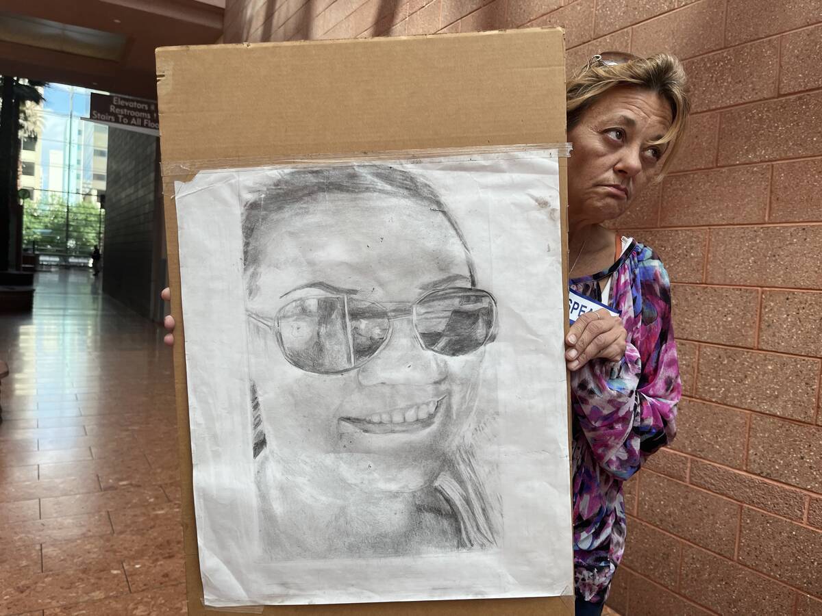 Lois Chase holds a picture of her daughter, Jamie Chase, at the Regional Justice Center on Tues ...