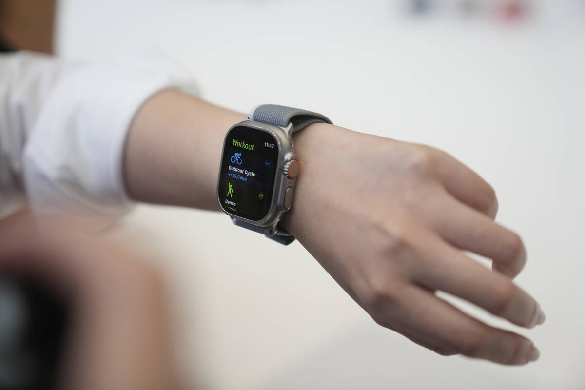 A person tries on an Apple Watch during an announcement of new products on the Apple campus, Tu ...