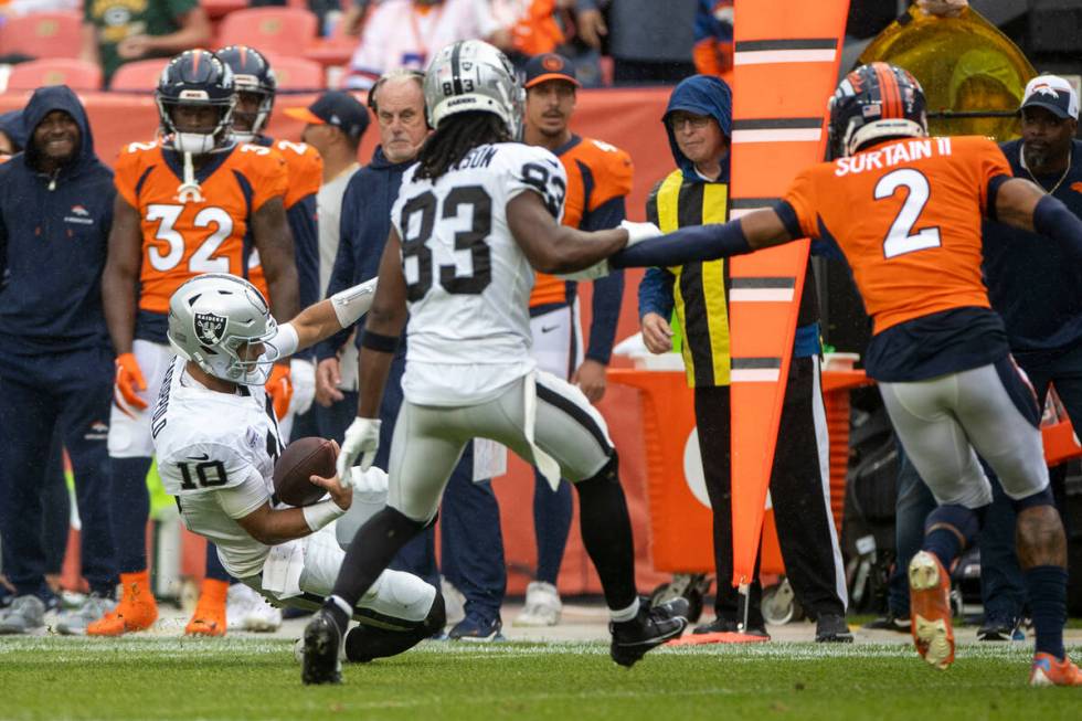 Raiders quarterback Jimmy Garoppolo (10) slides for a first down during the second half of an N ...