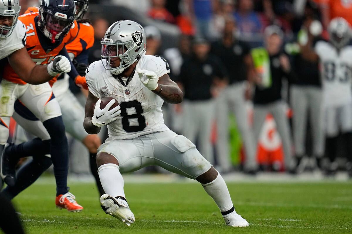 Las Vegas Raiders running back Josh Jacobs (8) runs against the Denver Broncos during an NFL fo ...