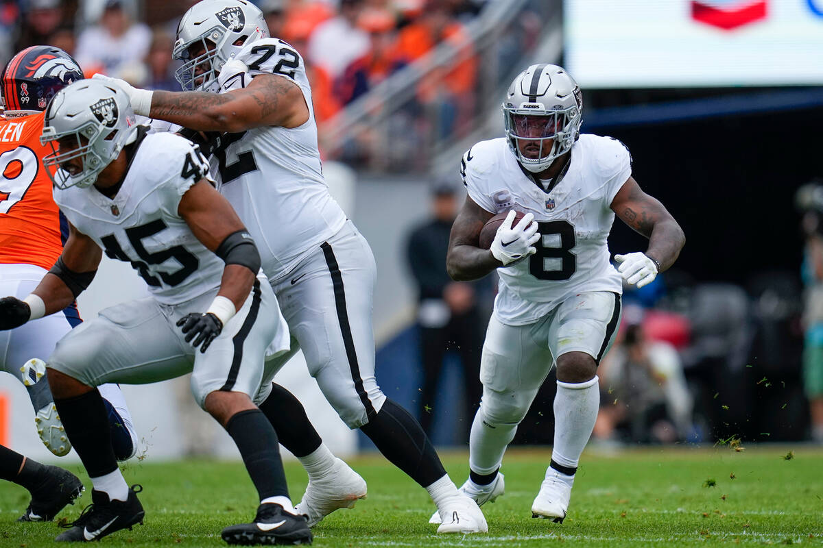 Las Vegas Raiders running back Josh Jacobs (8) rushes against the Denver Broncos during an NFL ...