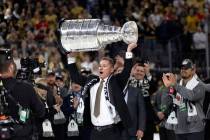 Golden Knights head coach Bruce Cassidy holds up his team’s Stanley Cup after they beat ...