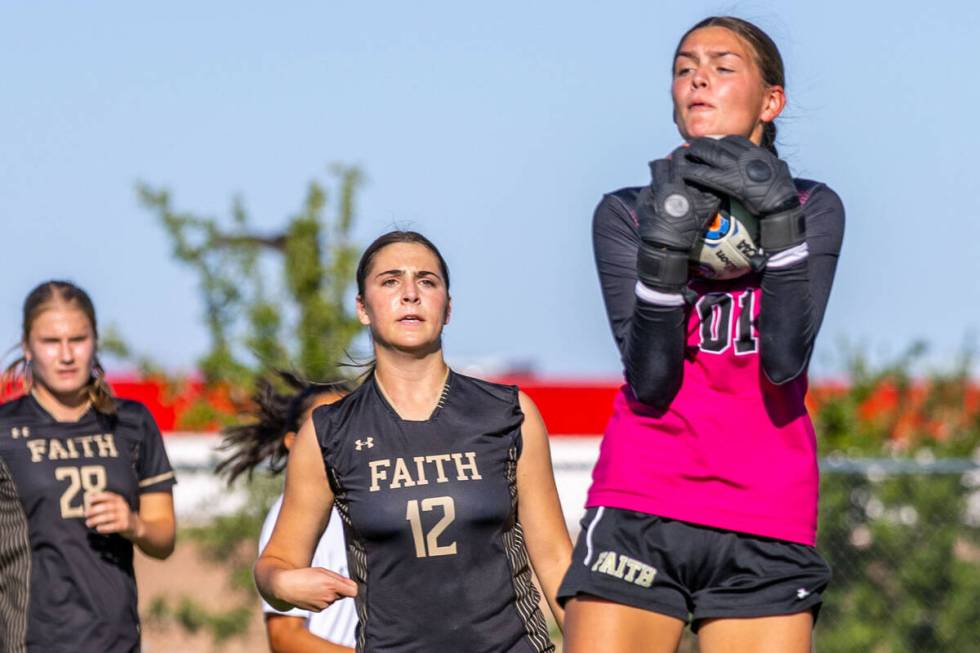 Faith Lutheran goalkeeper Demi Gronauer (01) grabs a shot on goal against Shadow Ridge during t ...