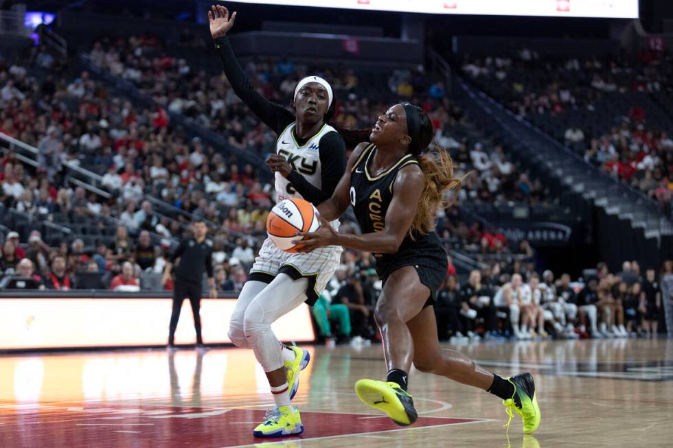 Las Vegas Aces guard Jackie Young (0) drives toward the hoop past Chicago Sky guard Kahleah Cop ...