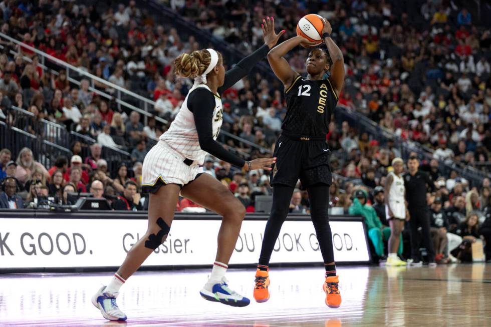 Las Vegas Aces guard Chelsea Gray (12) shoots against Chicago Sky forward Ruthy Hebard (24) dur ...