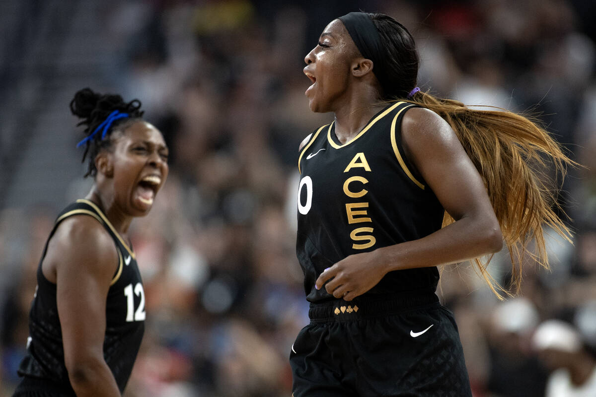Las Vegas Aces guard Jackie Young (0) and guard Chelsea Gray (12) celebrate after Young scored ...